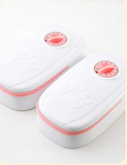 Automatic pet feeder and water dispenser for cats and dogs with gravity feeding system in pink and gray colors