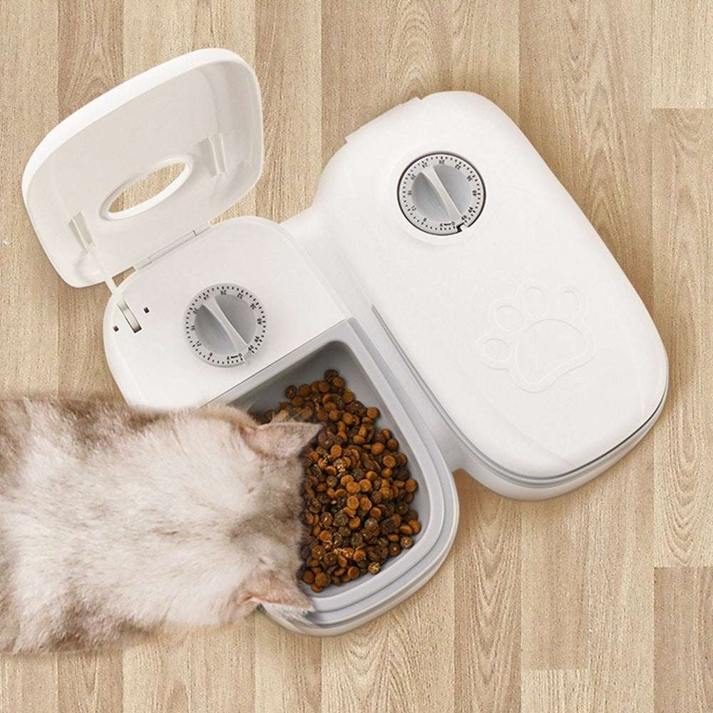 Automatic pet feeder with gravity food and water dispenser for cats and dogs in pink and gray plastic