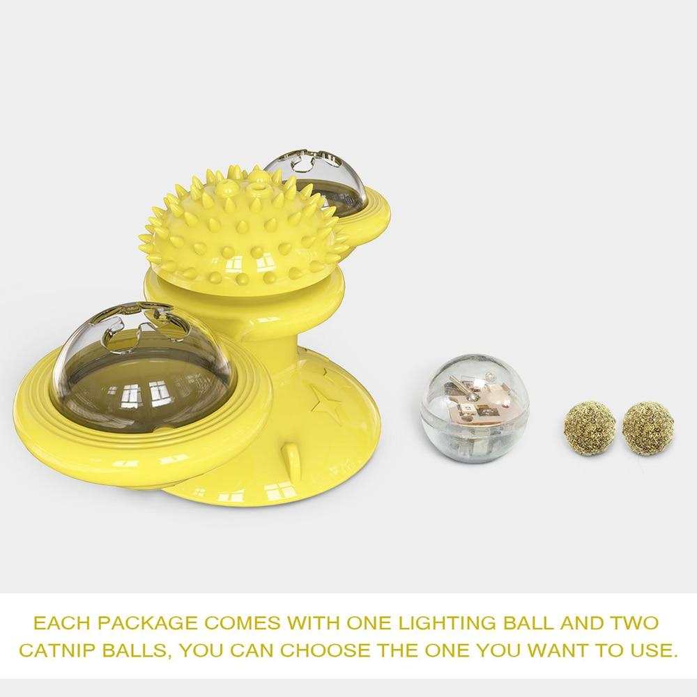 Cats playing with colorful whirling LED balls windmill toy with suction cup base